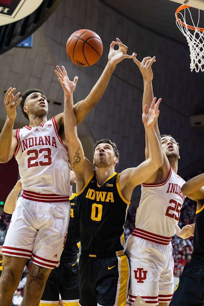 Indiana Hoosiers forward Trayce Jackson-Davis (23), forward Race Thompson (25) and Iowa Hawkeyes forward Filip Rebraca (0) fight for a rebound in the first half at Simon Skjodt Assembly Hall.